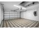 Spacious garage with patterned flooring and ample room for parking and storage at 11218 Sun Tree Rd, Hudson, FL 34667