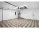 Spacious garage with patterned flooring, water heater, and ample room for parking and storage at 11218 Sun Tree Rd, Hudson, FL 34667