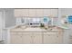 Bright kitchen featuring a large sink, modern appliances, and updated cabinets at 11218 Sun Tree Rd, Hudson, FL 34667