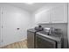 Well-equipped laundry room with modern washer and dryer units, and ample storage space at 11218 Sun Tree Rd, Hudson, FL 34667