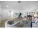 Bright living room with hardwood floors and neutral decor flowing into the dining area at 11218 Sun Tree Rd, Hudson, FL 34667