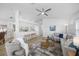 Open-concept living space featuring a modern ceiling fan, breakfast bar, and neutral color palette at 11218 Sun Tree Rd, Hudson, FL 34667