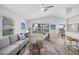 Bright living room with vaulted ceilings, ceiling fan, and large windows with neighborhood views at 11218 Sun Tree Rd, Hudson, FL 34667