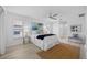 Bright main bedroom features wood-look floors, a ceiling fan, and large windows at 11218 Sun Tree Rd, Hudson, FL 34667