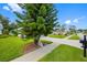 Serene neighborhood street featuring lush green lawns, sidewalks, and mature trees, perfect for a peaceful setting at 11218 Sun Tree Rd, Hudson, FL 34667