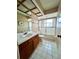 Bathroom featuring a vanity with wood cabinets, tile flooring, and a glass-enclosed shower at 114 Clays Trl # 114, Oldsmar, FL 34677
