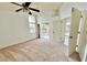 Bedroom with carpet, fan, and a balcony overlooking a waterfront view at 114 Clays Trl # 114, Oldsmar, FL 34677
