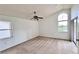 Spacious bedroom with carpet, ceiling fan, slider to the outside, and natural light at 114 Clays Trl # 114, Oldsmar, FL 34677