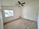 Bedroom with a ceiling fan, carpet flooring, and a window providing natural light at 114 Clays Trl # 114, Oldsmar, FL 34677