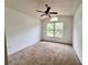 Bedroom with carpet, ceiling fan, and a window offering a view of the outdoors at 114 Clays Trl # 114, Oldsmar, FL 34677