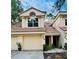 Inviting two-story townhouse featuring a tile roof, a one-car garage, and well-maintained landscaping at 114 Clays Trl # 114, Oldsmar, FL 34677