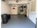 Garage interior featuring ample space for storage and parking, with organized shelving at 114 Clays Trl # 114, Oldsmar, FL 34677