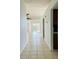 Bright hallway featuring neutral-toned tile floors leading into an airy living space at 114 Clays Trl # 114, Oldsmar, FL 34677