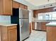 Functional kitchen with stainless steel appliances, oak cabinetry, and ample counter space at 114 Clays Trl # 114, Oldsmar, FL 34677