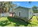Charming backyard featuring a screened lanai, privacy fence, and manicured landscaping at 11932 Whisper Creek Dr, Riverview, FL 33569