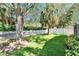 Lush backyard with mature trees, green lawn and white picket fence at 11932 Whisper Creek Dr, Riverview, FL 33569