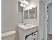 Nicely tiled bathroom with a vanity sink, toilet, vanity mirror and white cabinets at 11932 Whisper Creek Dr, Riverview, FL 33569
