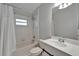 Nicely tiled bathroom with a sink, toilet, bathtub with shower, and white cabinets at 11932 Whisper Creek Dr, Riverview, FL 33569