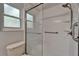 The tiled shower features sliding glass doors, a shower head and a grab bar at 11932 Whisper Creek Dr, Riverview, FL 33569