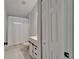 Nicely tiled bathroom with a sink, toilet, shower with white curtain, and white cabinets at 11932 Whisper Creek Dr, Riverview, FL 33569