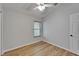 Bright bedroom with hardwood floors, ceiling fan, a window and light walls at 11932 Whisper Creek Dr, Riverview, FL 33569