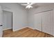 Bright bedroom with hardwood floors, ceiling fan, closet and a door at 11932 Whisper Creek Dr, Riverview, FL 33569