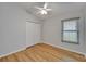 Bright bedroom with hardwood floors, ceiling fan, closet and window with blinds at 11932 Whisper Creek Dr, Riverview, FL 33569