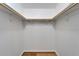 Walk-in closet with built-in shelving and wood flooring at 11932 Whisper Creek Dr, Riverview, FL 33569
