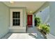 Entrance featuring a vibrant red door with an oval window, offering a pop of color at 11932 Whisper Creek Dr, Riverview, FL 33569