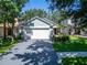 Charming single-story home with a two-car garage, a well-kept lawn, and mature trees at 11932 Whisper Creek Dr, Riverview, FL 33569