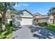 Charming home featuring an attached two-car garage and lush front yard landscaping at 11932 Whisper Creek Dr, Riverview, FL 33569