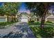 Charming single-story home with a well-maintained lawn and a colorful front door at 11932 Whisper Creek Dr, Riverview, FL 33569