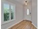 Foyer with wood floor and white door with accent window at 11932 Whisper Creek Dr, Riverview, FL 33569