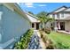 Inviting walkway leads to a red front door, complemented by manicured landscaping and a green lawn at 11932 Whisper Creek Dr, Riverview, FL 33569