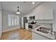 Modern kitchen with stainless steel appliances, granite countertops, and wood flooring at 11932 Whisper Creek Dr, Riverview, FL 33569
