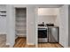 Convenient laundry room with stainless steel washer and dryer, along with shelving at 11932 Whisper Creek Dr, Riverview, FL 33569
