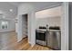 Convenient laundry room with stainless steel washer and dryer, along with shelving for storage at 11932 Whisper Creek Dr, Riverview, FL 33569