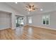 Living room features wood flooring, ceiling fan, and natural light at 11932 Whisper Creek Dr, Riverview, FL 33569
