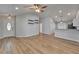Open living space with wood floors, sleek wall shelving, and an inviting atmosphere at 11932 Whisper Creek Dr, Riverview, FL 33569