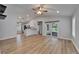 Open-concept living room with sleek wood flooring and sliding glass doors to screened-in patio at 11932 Whisper Creek Dr, Riverview, FL 33569