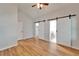 Bright main bedroom boasts wood floors and sliding barn doors to the bathroom and closet at 11932 Whisper Creek Dr, Riverview, FL 33569