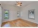 This bedroom features wood floors and multiple windows allowing for natural light at 11932 Whisper Creek Dr, Riverview, FL 33569