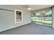 Screened patio with ceiling fan, window, and view of a white picket fence and green grass at 11932 Whisper Creek Dr, Riverview, FL 33569