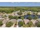 This aerial shot shows a neighborhood surrounding a lake with forest behind it at 12351 Ridgedale Dr, Hudson, FL 34669