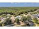 An aerial view of the house with a view of the surrounding houses, lakes, and greenery at 12351 Ridgedale Dr, Hudson, FL 34669