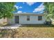 The backyard features a patio, a sliding door, and windows on the exterior of the home at 12351 Ridgedale Dr, Hudson, FL 34669