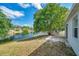 The backyard is adjacent to a lake and shaded by a large, mature tree at 12351 Ridgedale Dr, Hudson, FL 34669