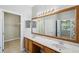 A bathroom features double sinks with marble countertops and a large framed mirror at 12351 Ridgedale Dr, Hudson, FL 34669