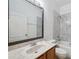 Bathroom with marble vanity top, new faucet and framed mirror and tiled walls at 12351 Ridgedale Dr, Hudson, FL 34669