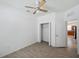 Bright bedroom with wood-look tile flooring, ceiling fan, and closet with double doors at 12351 Ridgedale Dr, Hudson, FL 34669